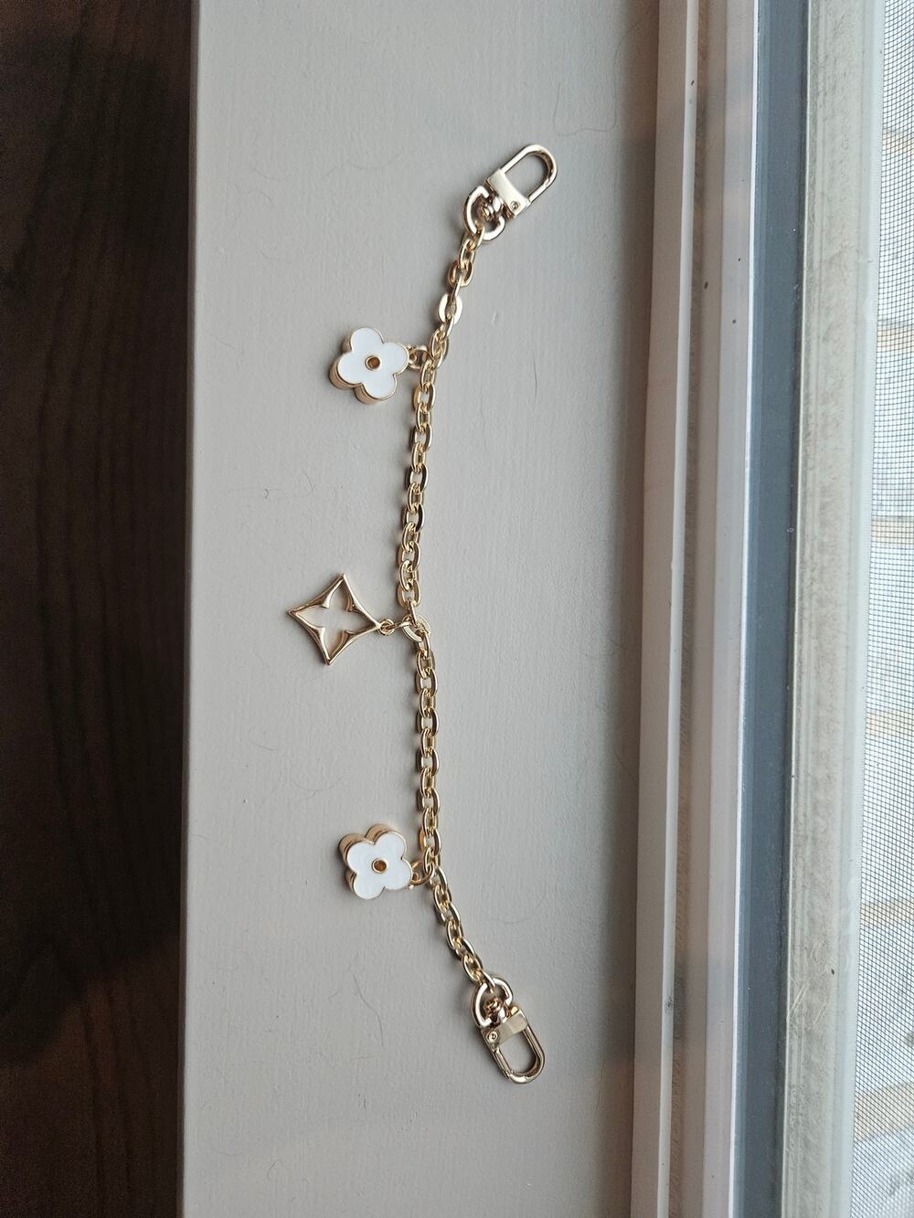 Unbranded fashion bag charm in gold with flowers and diamond shape charm